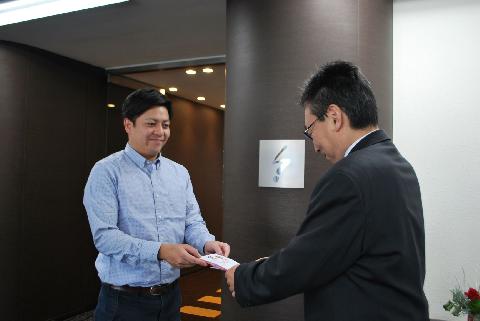 寄付金を手渡す安藤亮一セールス・アシスタント
